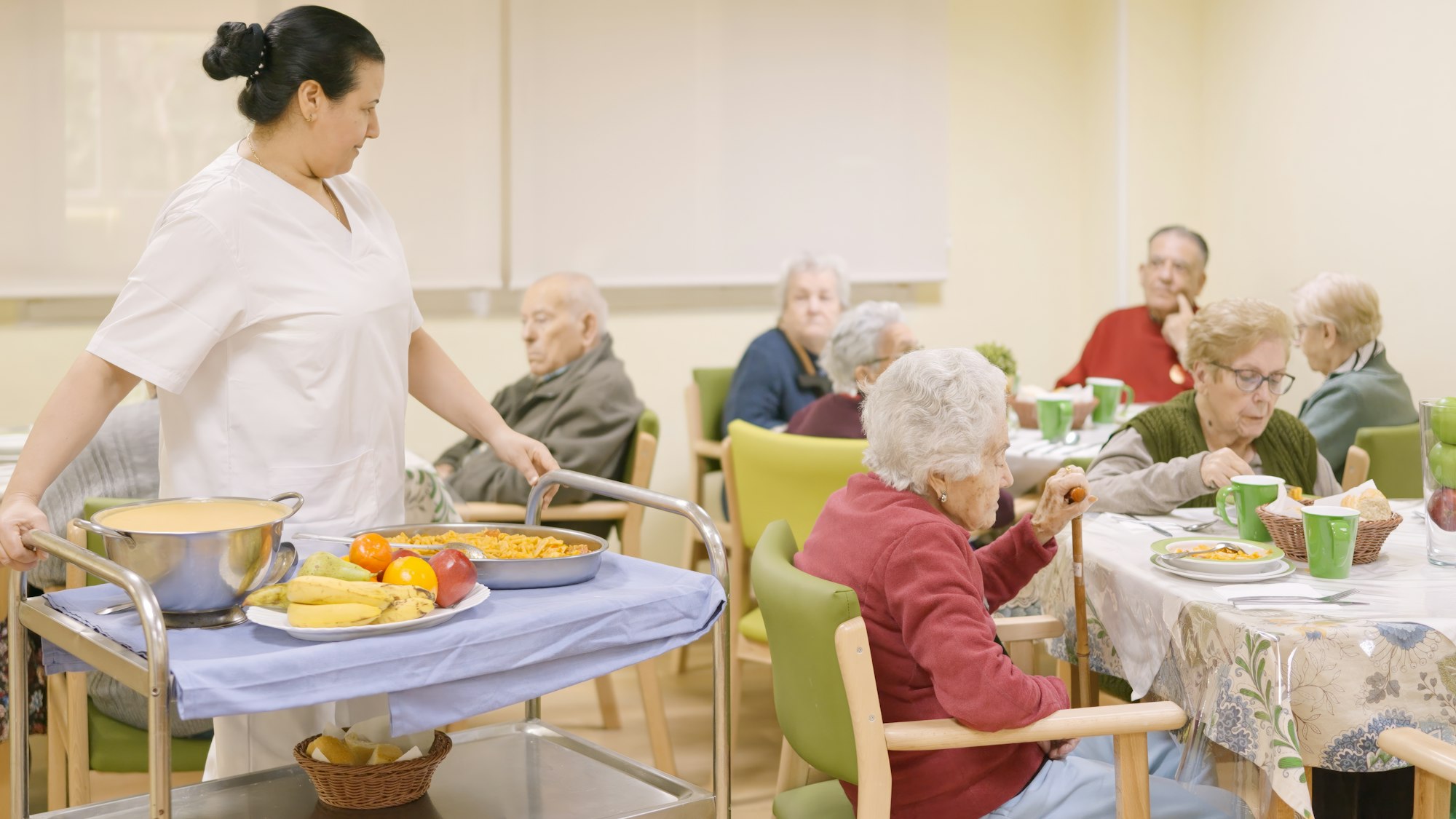 Cook entering with food to the dining room of geriatric