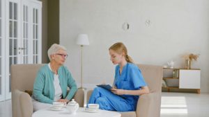 Home - Residència Geriàtrica Vallès Senior woman with short haircut talks to young female doctor writing notes on clipboard